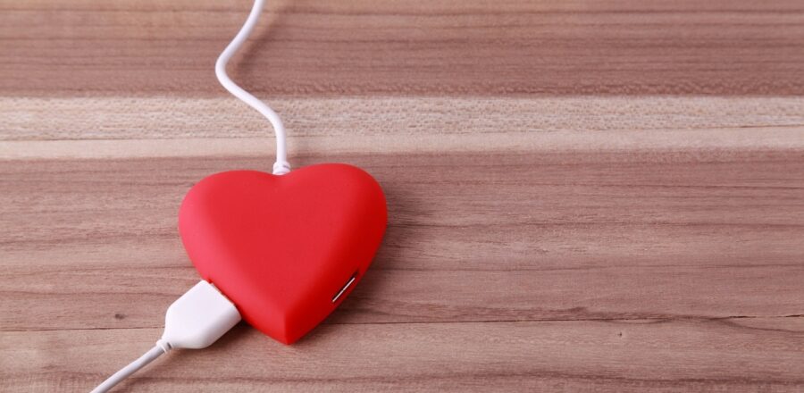 a computer power cord plugged into a heart-shaped pillow