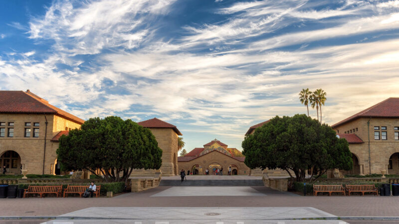 Photo of the Stanford University Quad under a blue sky with fluffy white clouds